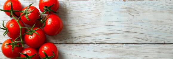 Fresh cluster of ripe red tomatoes with green stems on a wooden surface. Vegetables, organic produce, healthy eating, natural food concept. . Banner. Copy space photo