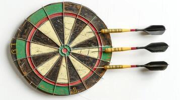 Vintage dartboard with three darts stuck in the bullseye. Concept of accuracy, precision, target practice, game strategy. Isolated on white background photo
