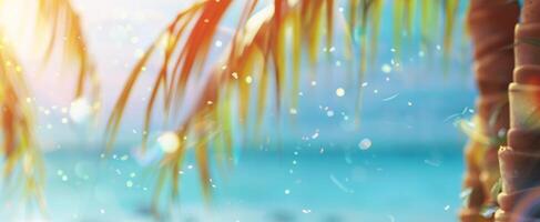 Bright tropical background with palm leaves, ocean with bokeh effect on sunny day. Vivid foliage under sunlight. Concept of summer vibe, nature's beauty, vacation. Wide tropical banner. Space for text photo