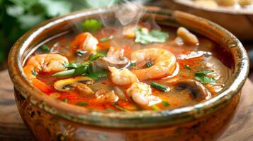 Authentic Thai Tom Yum soup in bowl, featuring prawns, mushrooms, fresh herbs. Aromatic and spicy broth. Concept Asian culinary, Thai cuisine, traditional dish photo
