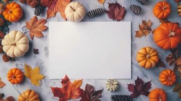 Elegant fall season mockup on marble background. White blank card surrounded by autumn pumpkins and leaves. Concept of Thanksgiving invitation, harvest festival, October decor, and classy backdrop. photo