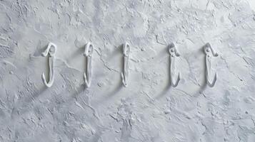 White abstract hooks on a textured white background Concept of modern design interior decoration minimalism and abstract art photo
