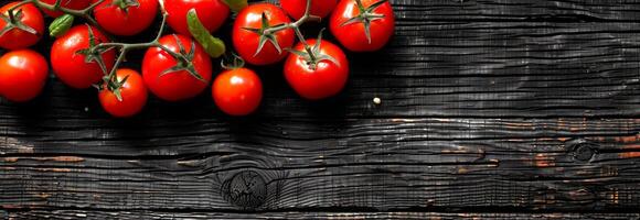 Red ripe tomatoes with stems on rustic wooden background. Fresh tomatoes, organic vegetables, healthy food, nature concept. Banner. Copy space photo