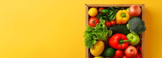 Fresh vegetables in a wooden crate on a yellow background. Healthy eating, organic produce, nutrition, farm-to-table. Concept of healthy lifestyle, diet, colorful food. Banner. Copy space photo