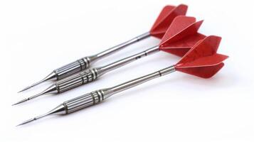 Golden darts with red flights isolated on a white background. Concept of leisure game, precision, sports hobby, fun activity photo