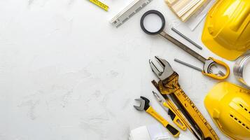 Yellow hard hats and assorted construction tools on a white background. Concept of construction, DIY projects, safety equipment, industrial tools. Copy space photo