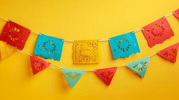 Vibrant Paper Banners with Festive Designs on a Yellow Background. Concept of Celebration, Festivity, Decorative Art, Colorfulness, papel picado photo