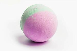 Bath bomb isolated on a white background. Fresh, clean look of a spherical bath accessory. Concept of spa, relaxation, hygiene, freshness, wellness and personal care. photo