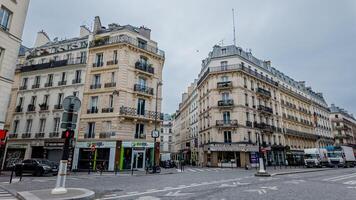 Quiet Parisian street corner with classic architecture on a cloudy spring day, captured in Paris, France, April 14th, 2024, ideal for travel and urban themes photo