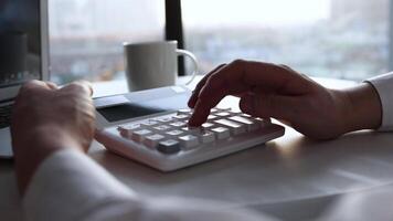 calculating accounts with-a-calculator-in-the-office video