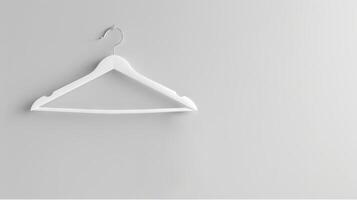 White Clothes Hanger on Plain White Wall. Concept of Organization, Minimalism, Simplicity, Interior Design. Copy space photo