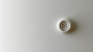 Modern white electrical socket on a minimalistic gray background. Energy connection. Concept of electricity, minimalism, home installation, utility photo