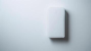 Minimalistic white Wi-Fi router against a plain wall. Concept of modern technology, wireless internet, connectivity, sleek design. Copy space photo