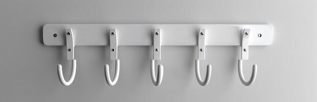White modern coat rack with five hooks mounted on a wall. Minimalist home organization concept. Concept of interior design, home storage, simplicity, functionality photo