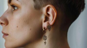 Elegant Woman Showcasing Unique Vintage Earrings on a Neutral Background photo