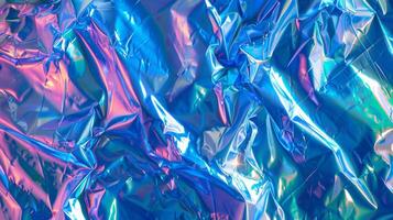 Iridescent Blue and Pink Metallic Wrinkled Foil Background with Vibrant Holographic Effect photo