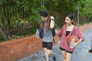 The male and female basketball players practice using the ball in the park court diligently and happily. photo