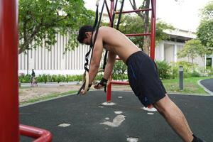 Asian men practicing swimming and polo and stretching and resting for water sports. photo