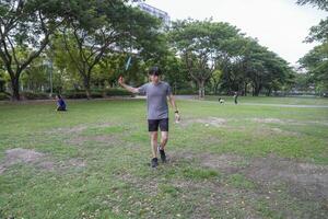 Young people play badminton and repair diligently in the park area. photo