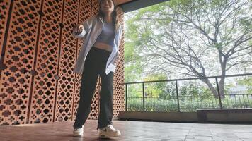 Asian girl dancing hip hop having fun With brightness and cheerfulness in the park area photo