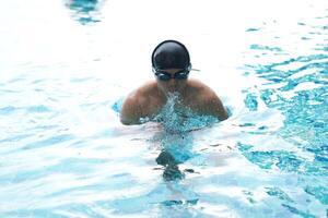 Asian men practicing swimming and preparing to play water polo and stretching and resting for water sports. photo