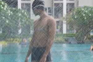 Asian men practicing swimming and preparing to play water polo and stretching and resting for water sports. photo