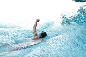 Asian men practicing swimming and preparing to play water polo and stretching and resting for water sports. photo