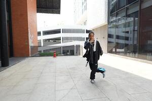 ASian man is dancing in hip hop style at outdoor space. Professional solo dancer is performing in public area. photo