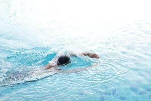 Asian men practicing swimming and preparing to play water polo and stretching and resting for water sports. photo