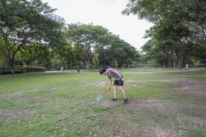 Young people play badminton and repair diligently in the park area. photo