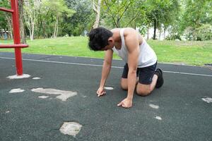 Asian man practicing gymnastics doing gymnastics bar and hoop exercises and stretching and resting for sports. photo