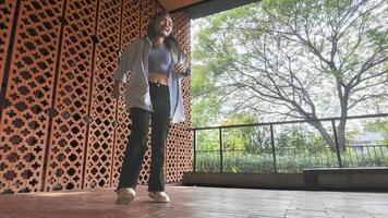 Asian girl dancing hip hop having fun With brightness and cheerfulness in the park area photo