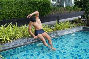Asian men practicing swimming and preparing to play water polo and stretching and resting for water sports. photo