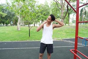 Asian man practicing gymnastics doing gymnastics bar and hoop exercises and stretching and resting for sports. photo