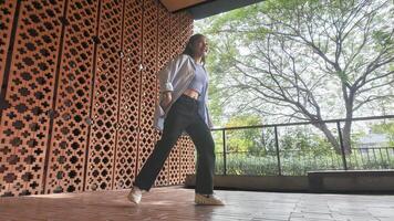 Asian girl dancing hip hop having fun With brightness and cheerfulness in the park area photo