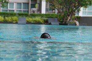 Asian men practicing swimming and preparing to play water polo and stretching and resting for water sports. photo