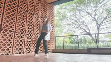 Asian girl dancing hip hop having fun With brightness and cheerfulness in the park area photo