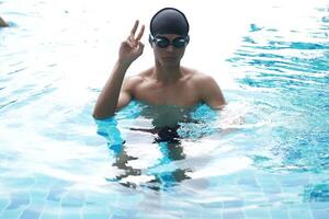 Asian men practicing swimming and preparing to play water polo and stretching and resting for water sports. photo
