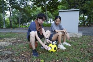 Male and female soccer players practice using the ball in the park field diligently and happily. photo