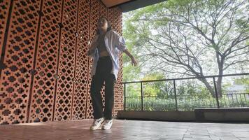 Asian girl dancing hip hop having fun With brightness and cheerfulness in the park area photo