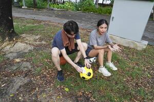 Male and female soccer players practice using the ball in the park field diligently and happily. photo