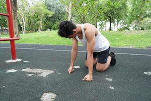 Asian man practicing gymnastics doing gymnastics bar and hoop exercises and stretching and resting for sports. photo