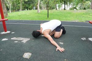 Asian man practicing gymnastics doing gymnastics bar and hoop exercises and stretching and resting for sports. photo