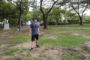 Male soccer players practice using the ball in the park field diligently and happily. photo