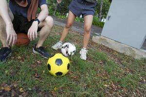 Male and female soccer players practice using the ball in the park field diligently and happily. photo