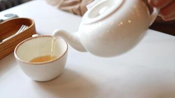 Close-up of a mug into which I pour tea from a teapot video