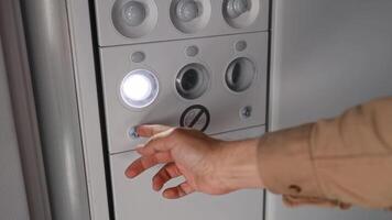 Enabling the flight attendant call button on the panel above the passenger seats in the aircraft cabin video