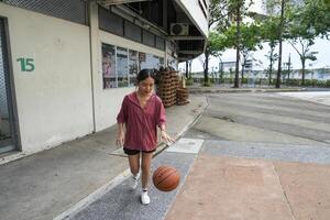 female basketball players practice using the ball in the park court diligently and happily. photo