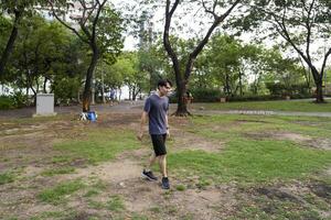 Male soccer players practice using the ball in the park field diligently and happily. photo