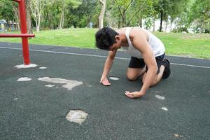 Asian man practicing gymnastics doing gymnastics bar and hoop exercises and stretching and resting for sports. photo